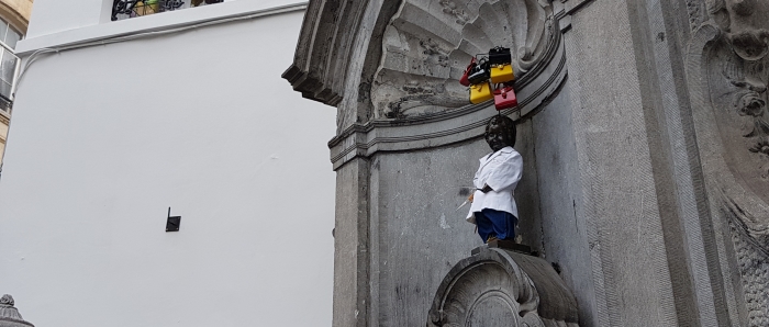 Manneken Pis statue in Brussels, Belgium, dressed in Delvaux for his Fashion Day