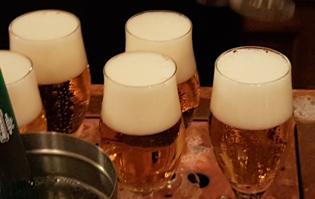 Glasses of Heineken at the Bar in the Heineken Experience in Amsterdam