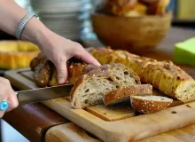 Someone slicing a Loaf of Bread in a Bakery in Paris