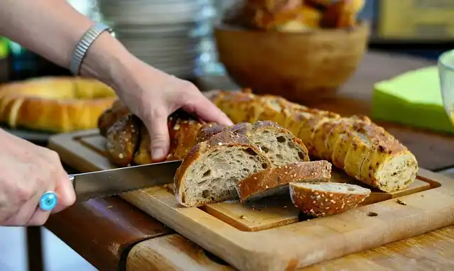 Someone slicing a Loaf of Bread in a Bakery in Paris